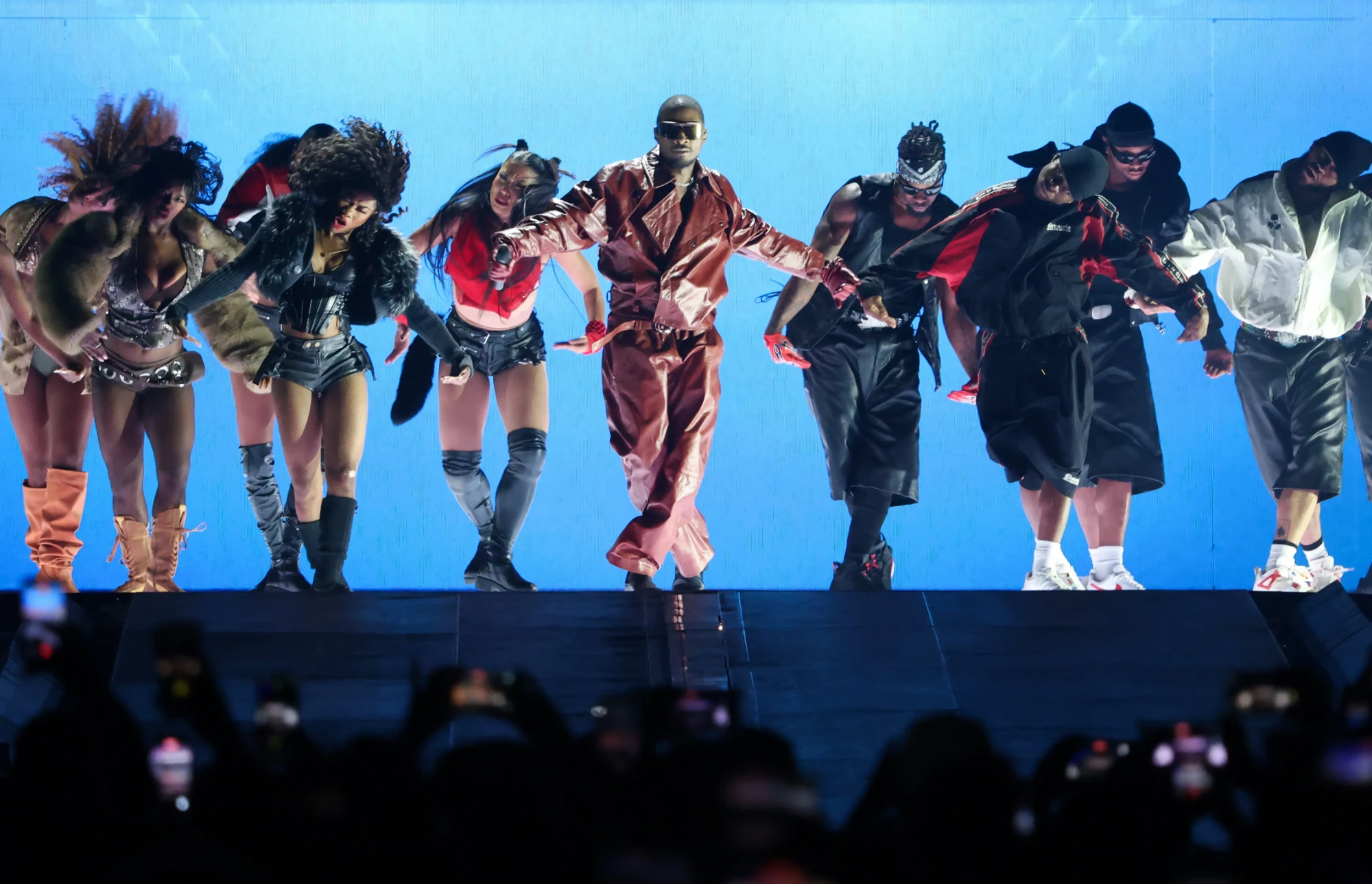 Usher performing with dancers on stage